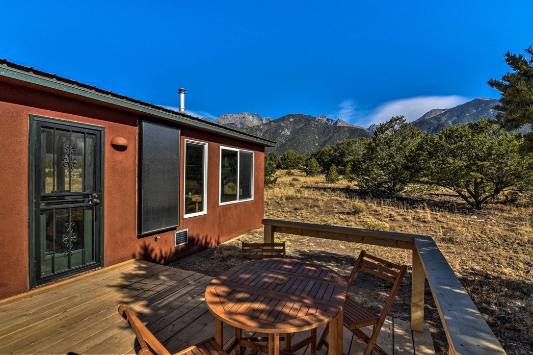 Cabin and deck with mountain backdrop