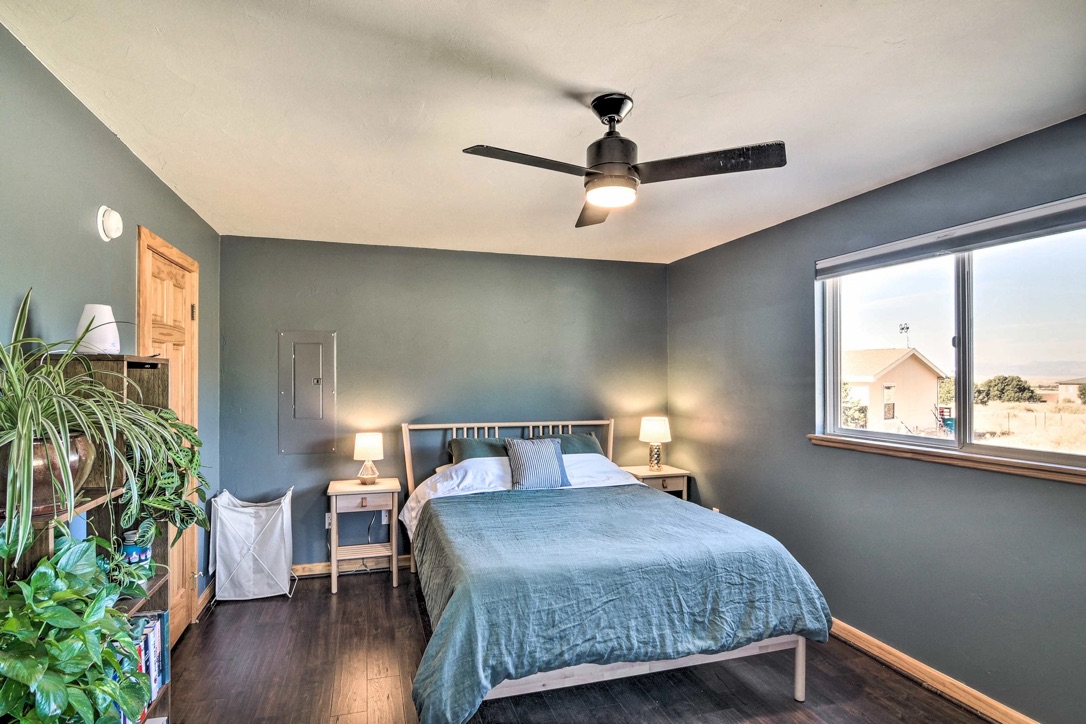 Bedroom with queen bed and plants