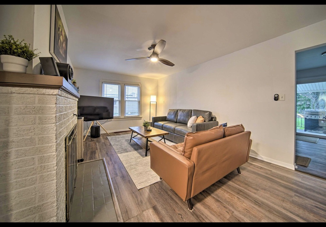 Living room with leather sofa and ceiling fan