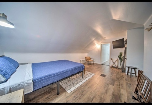 Attic bedroom with blue bedding