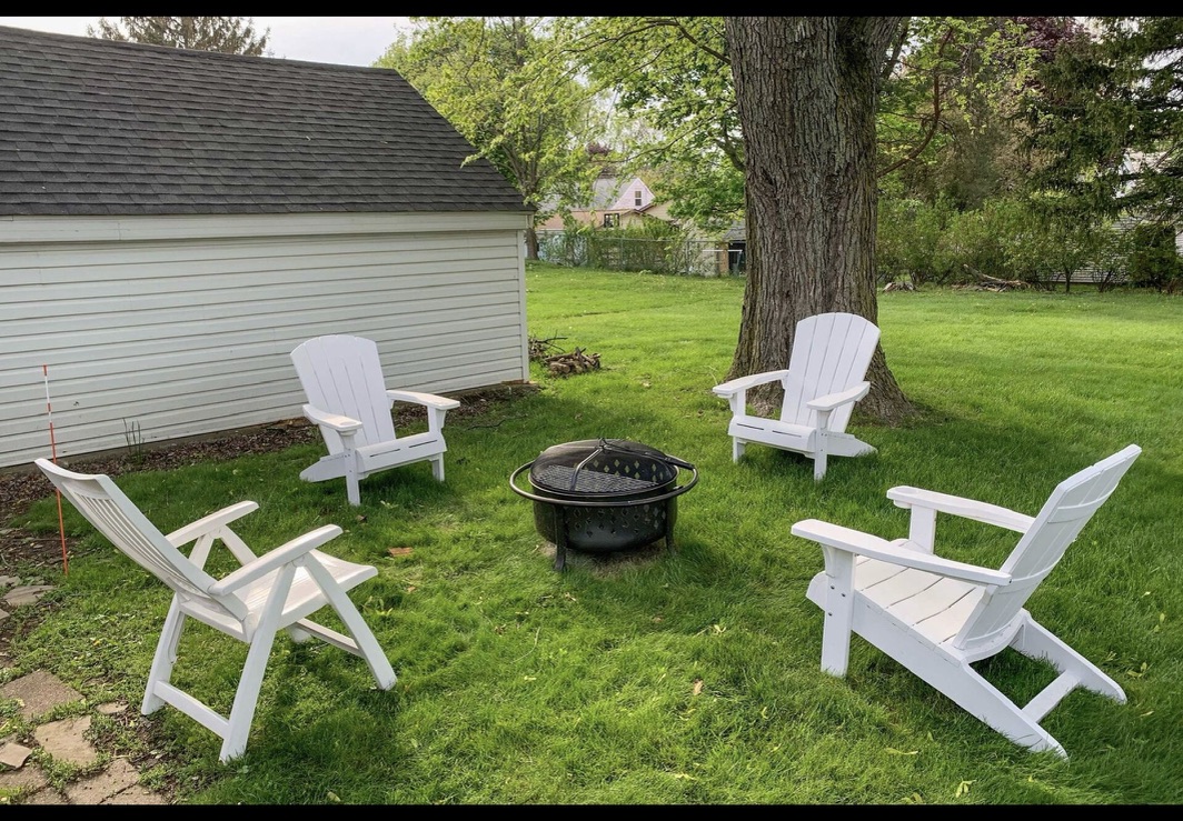 Backyard fire pit with Adirondack chairs