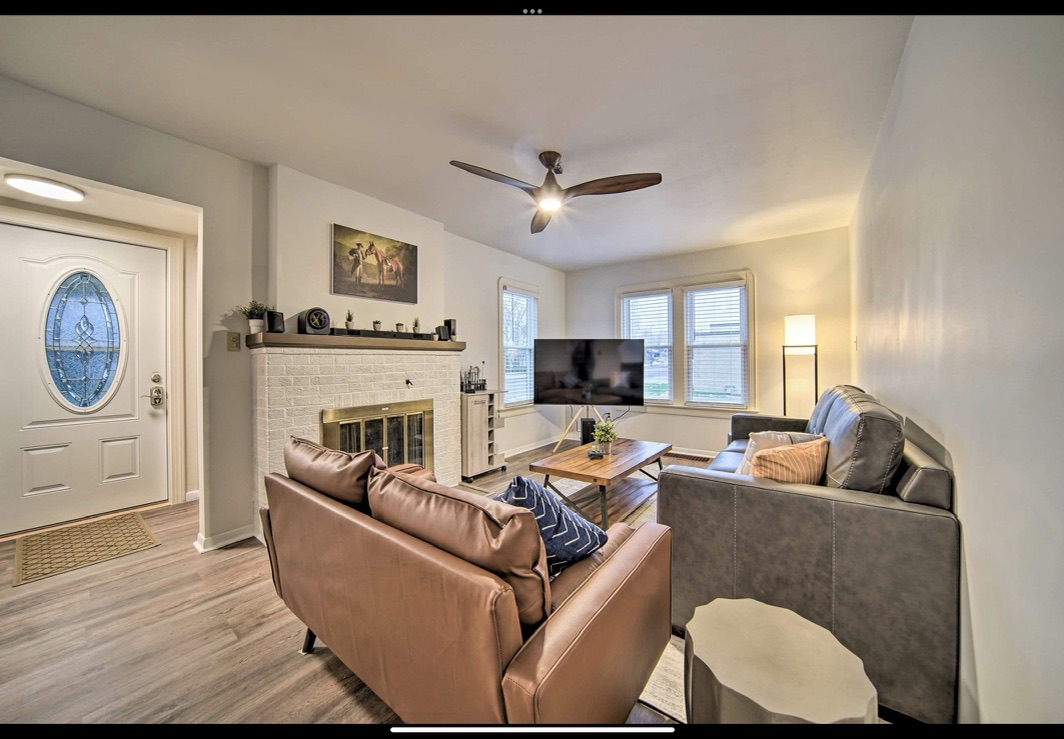 Living room with front door and fireplace